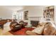 Spacious living room featuring a fireplace, piano, and bookshelves, plus a leather sofa and armchairs, all on hardwood floors at 5219 N New Jersey St, Indianapolis, IN 46220