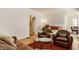 Comfortable living room featuring a fireplace, piano, and leather furniture, complemented by hardwood floors at 5219 N New Jersey St, Indianapolis, IN 46220