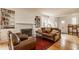 Bright living room showcasing a fireplace flanked by bookshelves, a leather sofa and armchairs, and wood floors at 5219 N New Jersey St, Indianapolis, IN 46220