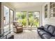 Bright sunroom with large windows, comfortable seating, and hardwood floors at 5219 N New Jersey St, Indianapolis, IN 46220
