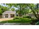 Beautiful backyard showcasing a well-maintained lawn, mature trees, a fence and a quaint outbuilding at 5280 N Capitol Ave, Indianapolis, IN 46208