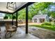 Inviting backyard features a covered porch, lush landscaping, and a detached building offering flexible space at 5280 N Capitol Ave, Indianapolis, IN 46208