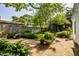 Expansive backyard with manicured lawn, mature trees, a wooden fence, and a charming garden at 5280 N Capitol Ave, Indianapolis, IN 46208