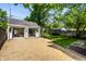 Backyard view featuring open garage with stylish seating and garden at 5280 N Capitol Ave, Indianapolis, IN 46208