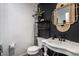 Bathroom featuring a vintage-style sink and a bold accent wall at 5280 N Capitol Ave, Indianapolis, IN 46208