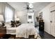 Bright bedroom featuring a large bed, modern dresser, ceiling fan, and a window seat at 5280 N Capitol Ave, Indianapolis, IN 46208