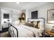 Cozy bedroom featuring a black metal frame bed and white bedding at 5280 N Capitol Ave, Indianapolis, IN 46208