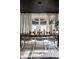 Elegant dining room with a dark wood table, modern chandelier, and neutral-toned curtains at 5280 N Capitol Ave, Indianapolis, IN 46208