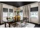 Elegant dining room featuring a black ceiling, modern chandelier, and neutral-toned curtains at 5280 N Capitol Ave, Indianapolis, IN 46208