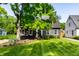 Charming house with a well-maintained lawn, lush tree, and classic architectural details at 5280 N Capitol Ave, Indianapolis, IN 46208