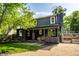 Exterior showcasing the back of the home, mature trees, covered porch and a well-maintained yard at 5280 N Capitol Ave, Indianapolis, IN 46208