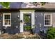 Inviting front entrance with a black door, decorative lighting, and well-kept landscaping at 5280 N Capitol Ave, Indianapolis, IN 46208