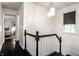 Hallway with black and white trim, wood floors, and modern lighting fixture at 5280 N Capitol Ave, Indianapolis, IN 46208