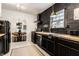Modern kitchen featuring dark cabinetry, butcher block countertops, and stainless steel appliances at 5280 N Capitol Ave, Indianapolis, IN 46208
