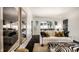 Elegant living room with a stylish zebra ottoman, white sofa, and unique wall mirrors at 5280 N Capitol Ave, Indianapolis, IN 46208