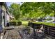 Cozy brick patio with outdoor seating, a patterned rug, and lush greenery at 5280 N Capitol Ave, Indianapolis, IN 46208
