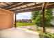View of the backyard and playset from covered back patio and brick exterior at 5457 W 900 North, McCordsville, IN 46055