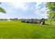 Large backyard with a deck, playground, water feature, and scenic views, ideal for outdoor enjoyment at 5457 W 900 North, McCordsville, IN 46055