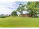 A spacious backyard with lush green grass and mature trees, ideal for outdoor activities at 5457 W 900 North, McCordsville, IN 46055