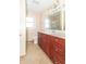 Bathroom featuring cherry vanity, tile floor, toilet, and lots of counter space at 5457 W 900 North, McCordsville, IN 46055