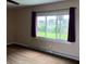 Bedroom featuring a large window, neutral walls, and baseboard heating at 5457 W 900 North, McCordsville, IN 46055