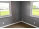 Cozy bedroom with neutral walls, large windows, and soft carpet flooring for a comfortable ambiance at 5457 W 900 North, McCordsville, IN 46055