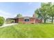 A well-maintained brick home with a covered patio and lush green lawn at 5457 W 900 North, McCordsville, IN 46055