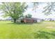 A brick home with mature trees and a well-kept front yard at 5457 W 900 North, McCordsville, IN 46055