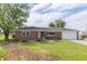 Charming single-story brick home with a well-maintained front yard, mature trees and an attached garage at 5457 W 900 North, McCordsville, IN 46055