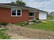 A brick single-story home offers a classic design, landscaping, and attached garage at 5457 W 900 North, McCordsville, IN 46055