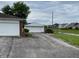 View of detached garage and neighboring homes in the neighborhood with green lawns at 5457 W 900 North, McCordsville, IN 46055