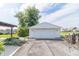 A detached two car garage features a white garage door and concrete driveway at 5457 W 900 North, McCordsville, IN 46055