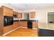 Well-appointed kitchen with custom cabinetry, modern appliances and an island for added prep space at 5457 W 900 North, McCordsville, IN 46055