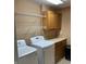 Laundry room with modern appliances, overhead shelving, and countertops at 5457 W 900 North, McCordsville, IN 46055