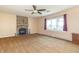 Spacious living room featuring a stone fireplace, plush carpeting, ceiling fan and ample natural light at 5457 W 900 North, McCordsville, IN 46055