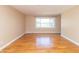 Bright living room featuring hardwood floors and a large window at 5457 W 900 North, McCordsville, IN 46055