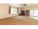 Comfortable living room with large windows, a ceiling fan, and built in shelves for extra storage at 5457 W 900 North, McCordsville, IN 46055
