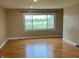 Bright living room featuring hardwood floors and a large window with beautiful outdoor views at 5457 W 900 North, McCordsville, IN 46055