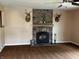 Living room with stone fireplace, wood-burning stove, and mounted deer decorations at 5457 W 900 North, McCordsville, IN 46055