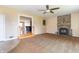 Spacious living room with a stone fireplace, plush carpeting and direct access to the kitchen at 5457 W 900 North, McCordsville, IN 46055