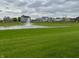 Scenic pond view surrounded by lush greenery and neighborhood homes creates a tranquil environment at 5457 W 900 North, McCordsville, IN 46055