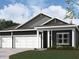 Charming home featuring a three-car garage, welcoming entrance, and traditional architectural details at 5863 Handbell Ln, Greenwood, IN 46143