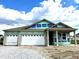 New construction featuring a two-car garage and a covered porch, showcasing modern design at 5863 Handbell Ln, Greenwood, IN 46143