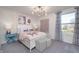 Charming bedroom featuring a white bed frame, unique artwork, stylish lighting, and a window view at 591 Dalton Way, Avon, IN 46123