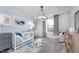 Adorable Bedroom with soft blue walls, playful artwork, a crib, and a comfortable seating area at 591 Dalton Way, Avon, IN 46123