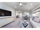 Upstairs bonus room features plush carpeting, comfortable seating, and plenty of space for entertaining at 591 Dalton Way, Avon, IN 46123