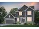 Charming two-story home boasts gray siding, a manicured lawn, and complemented by lush landscaping at 591 Dalton Way, Avon, IN 46123