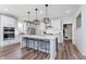 Stylish kitchen with a large island, modern pendant lights, stainless steel appliances, and pristine white cabinetry at 591 Dalton Way, Avon, IN 46123