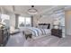 Beautiful main bedroom with natural light, neutral colors, a decorative wall, and luxurious bedding at 591 Dalton Way, Avon, IN 46123