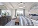 Bright main bedroom boasts natural light, tray ceilings, a decorative headboard, and stylish decor at 591 Dalton Way, Avon, IN 46123